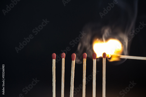 Burning matches on black background