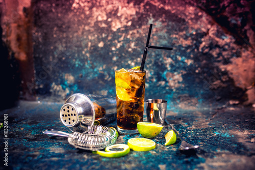 Alcoholic cocktail beverage, cuba libre drink with garnish and metal background photo