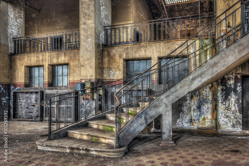 Imposing staircase inside the hall of an abandoned power plant