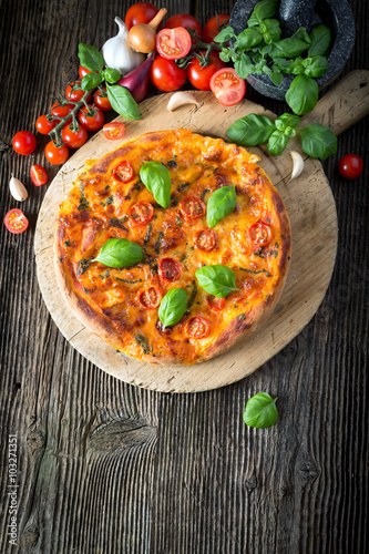 homemade pizza margherita with mozzarella, basil and tomatoes