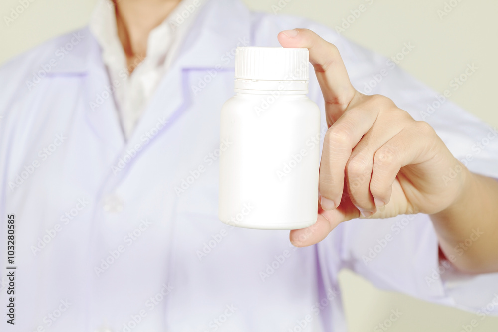 hand of doctor holding medicine bottle on white background