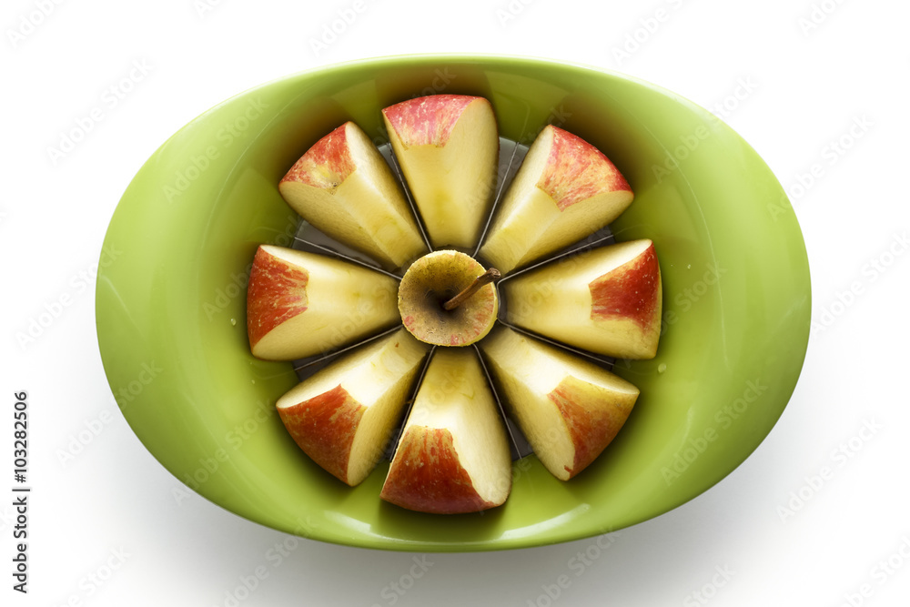 Green apple slicer with sliced apple segments from above, isolat Green apple slicer with sliced apple segments from above, isolat