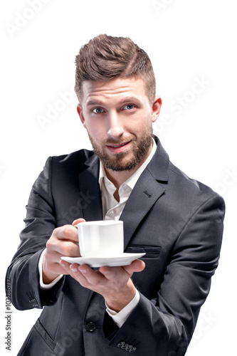 Studio shot of a man with white coffee cup, isolated on white © zamuruev