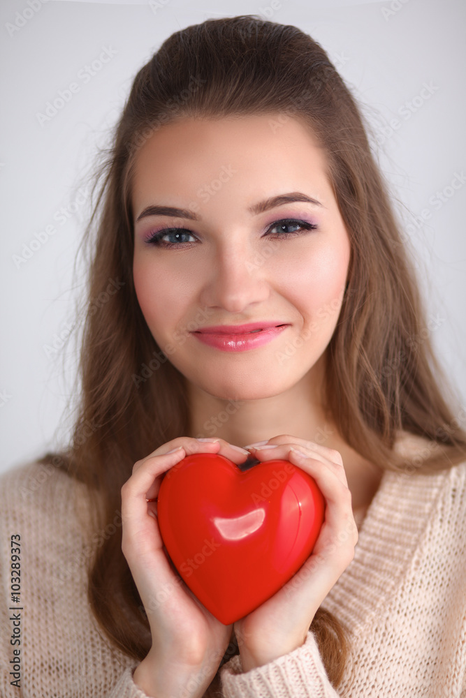 Portrait of beautiful happy woman holding a symbol heart. Portrait of beautiful happy woman holding a symbol heart.
