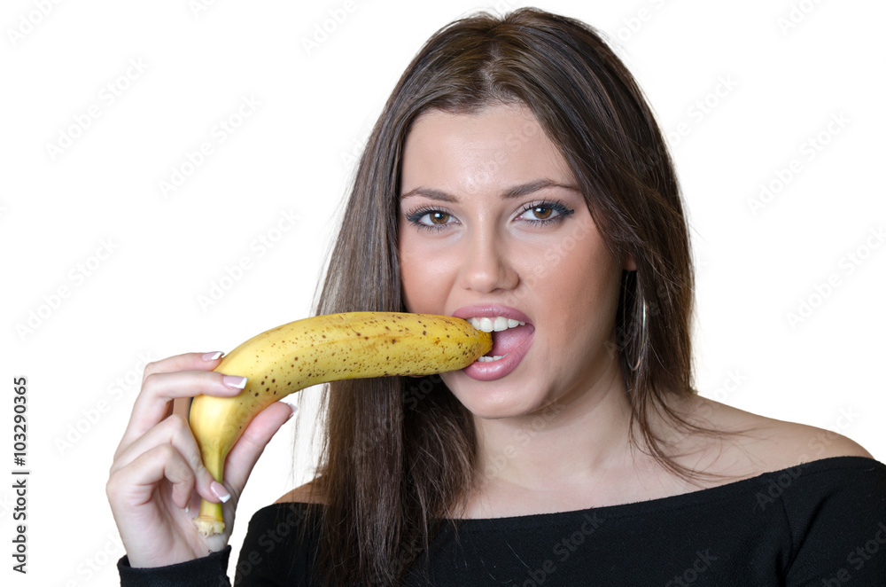 Cute brunette lady wear black shirt, holding and biting a banana Cute brunette lady wear black shirt, holding and biting a banana