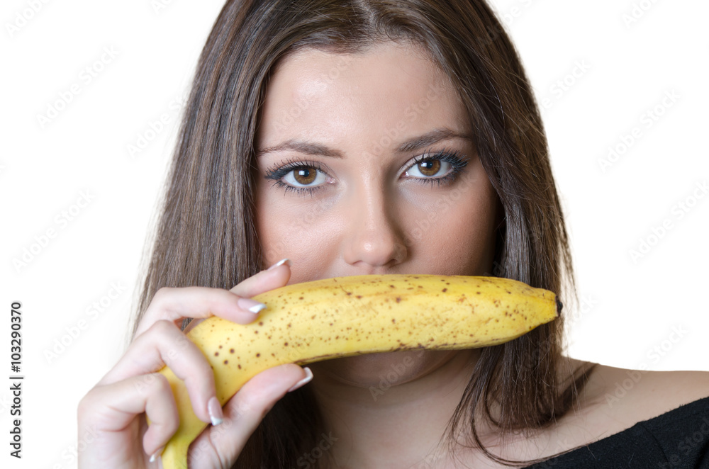 Cute brunette lady wear black shirt, holding a banana under her nose Cute brunette lady wear black shirt, holding a banana under her nose