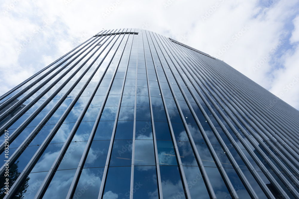 Clouds reflected in windows of modern office building Clouds reflected in windows of modern office building