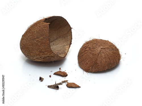 Still life with empty crushed coconut shell and smithers isolated on white background. Horizontal close-up photo photo