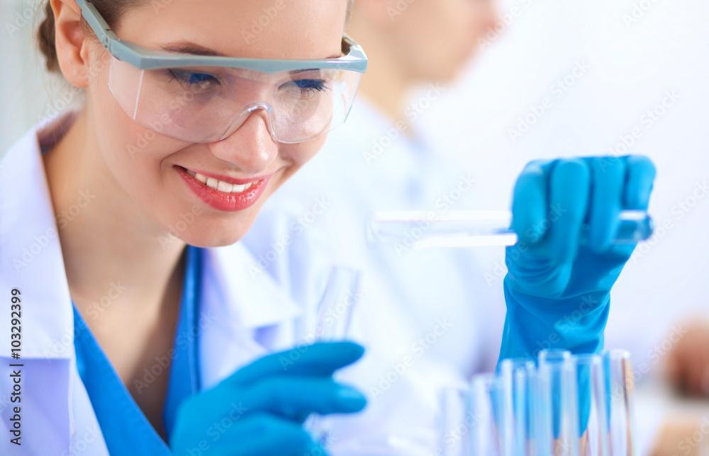 Fototapeta premium Woman researcher is surrounded by medical vials and flasks, isolated on white background