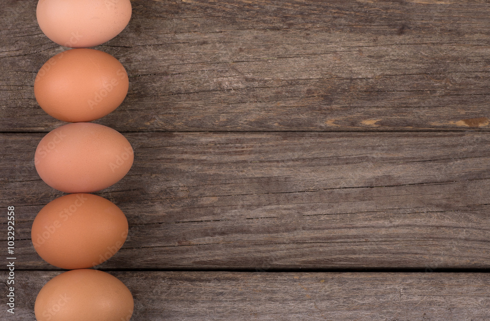 Row of Brown Eggs on a Rustic Wooden Background Row of Brown Eggs on a Rustic Wooden Background