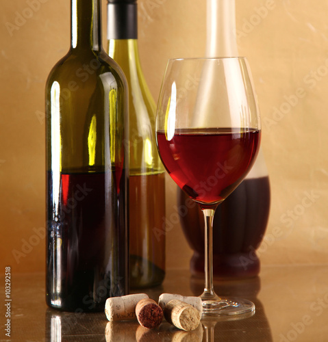 wine bottle and wine glass on a glass table