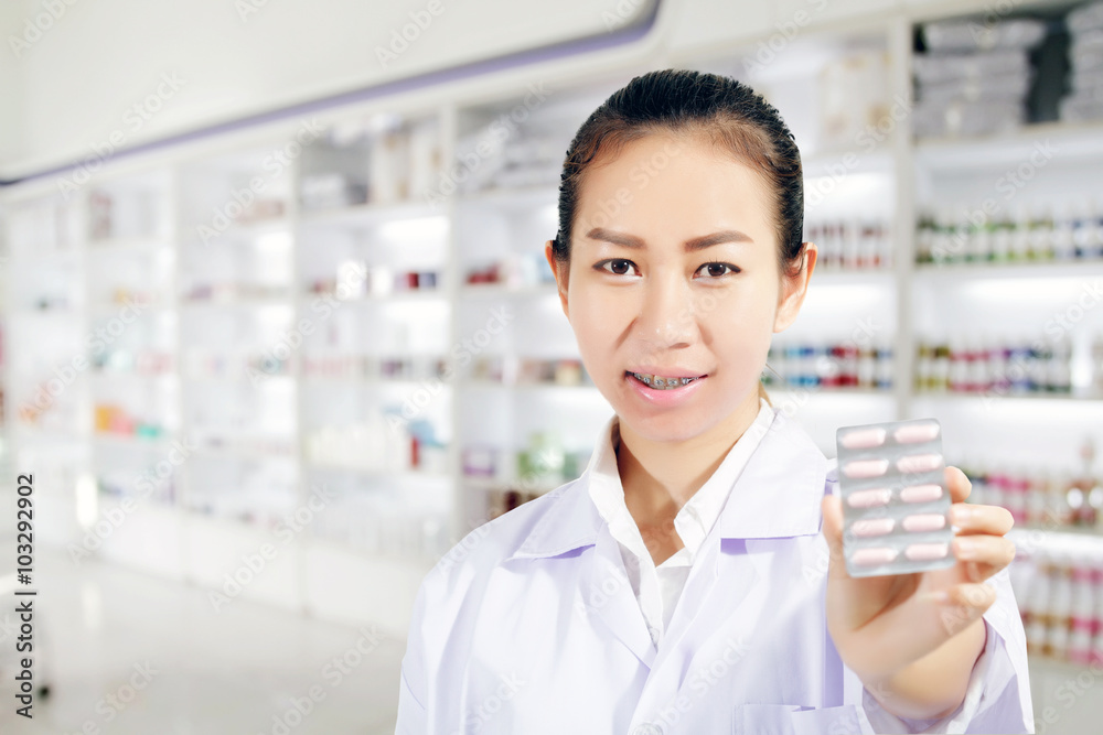Pharmacist and Doctor woman holding pill in hand , health care a