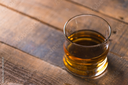 whiskey in glass on wood background