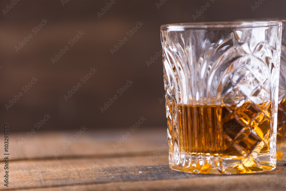 whiskey in glass on wood background