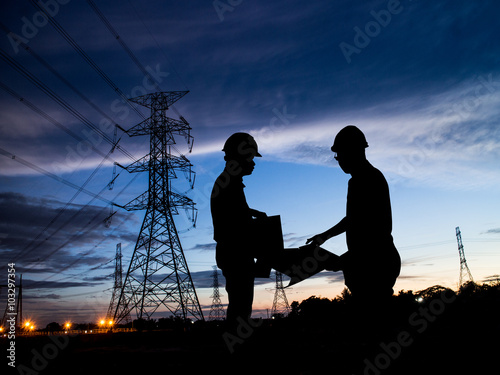 silhouette man of engineers standing at electricity station over