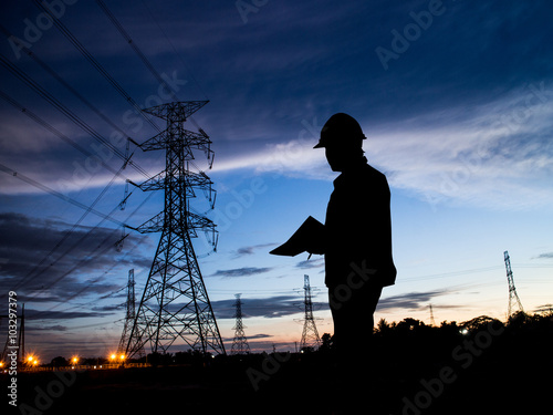 silhouette man of engineers standing at electricity station over