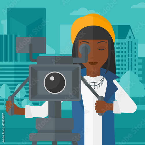 Camerawoman with movie camera on a tripod.