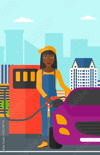 Woman filling up fuel into car.