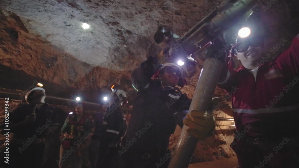 Workers in mine perforating the rock using a pneumatic drill Workers in mine perforating the rock using a pneumatic drill