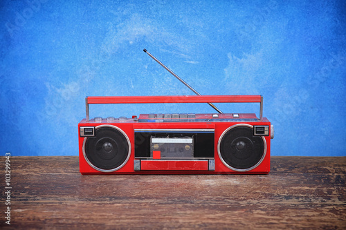 old retro radio on table blue background