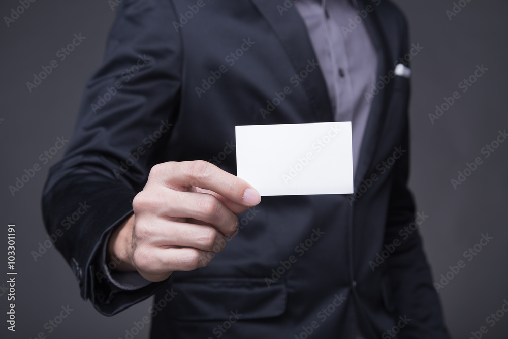 Businessman holding a card. Businessman holding a card.