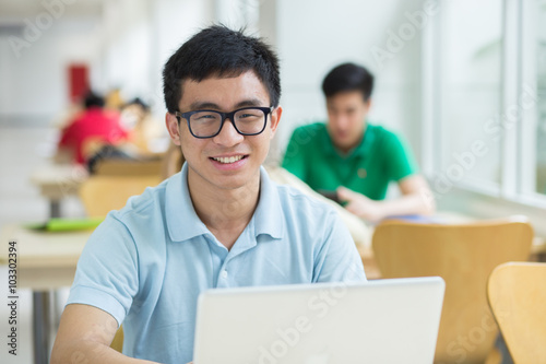 Student using a laptop in the library.