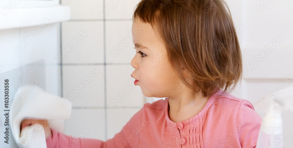 Toddler girl cleaning the kitchen Toddler girl cleaning the kitchen