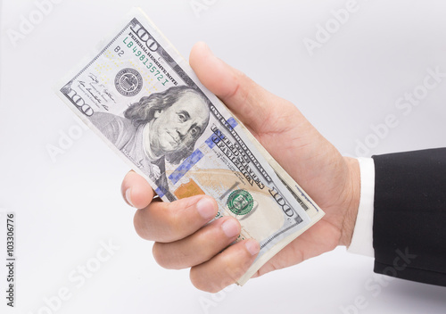 US dollars in business hand isolated on a white background