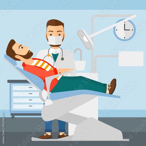 Dentist and man in dentist chair.