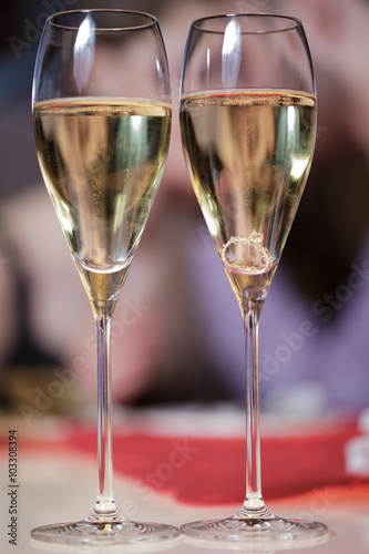 Two glasses of champagne and the ring on it