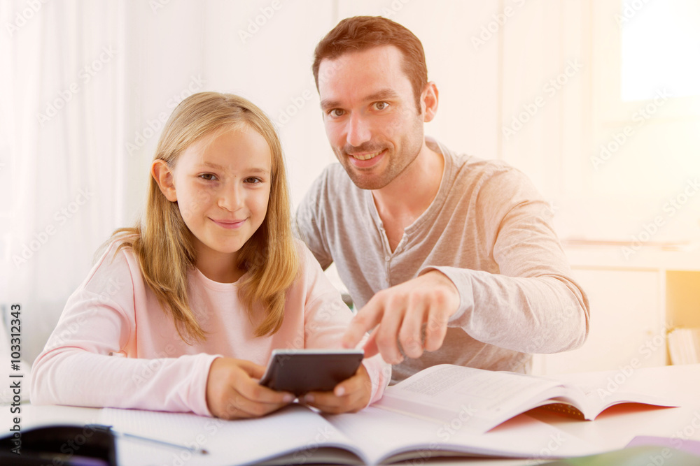 Father helping out her daughter for homework Father helping out her daughter for homework