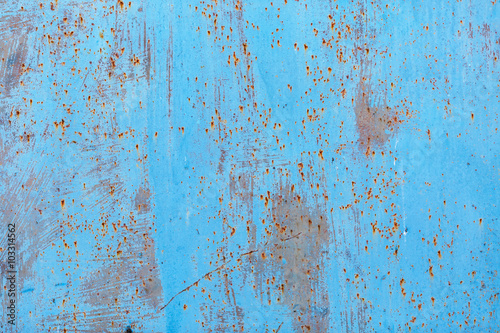 Peeling paint texture with rust stains. Old blue grunge background.