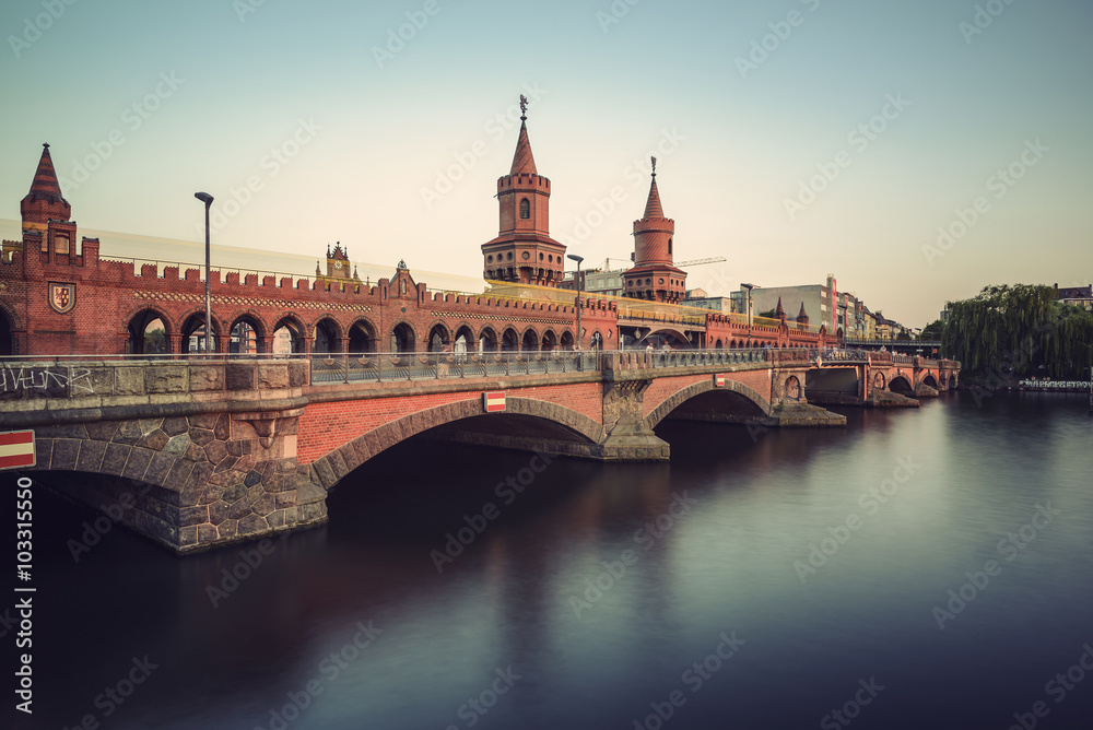 historical Oberbaum bridge (Oberbaumbruecke) and the river Spree in Berlin, Germany, Europe, vintage filtered style
