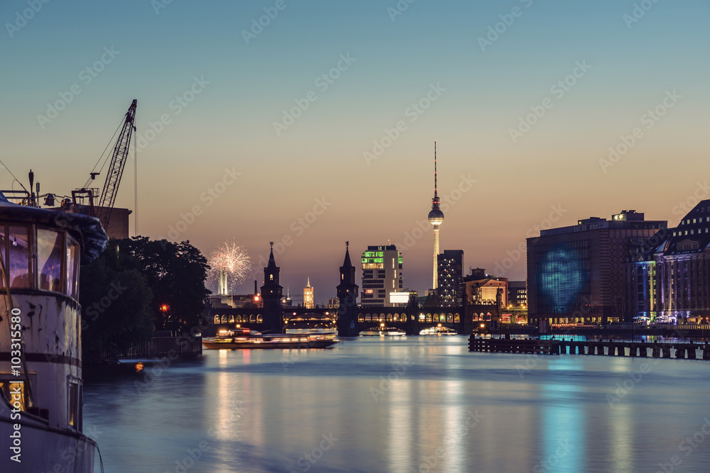 Fototapeta Fireworks above Berlin Skyline, TV Tower, Oberbaumbruecke and Spree River at evening, Germany, Europe, vintage filtered style