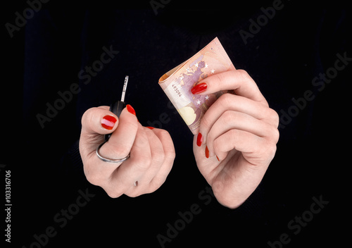 Woman's hands with eurobanknotes and car keys photo