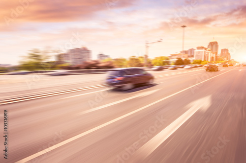 Car driving on road at sunset, motion blur © 06photo