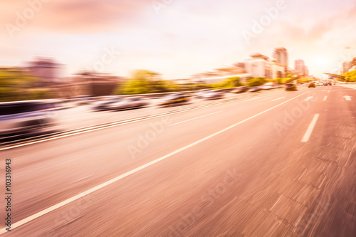 Car driving on road at sunset, motion blur