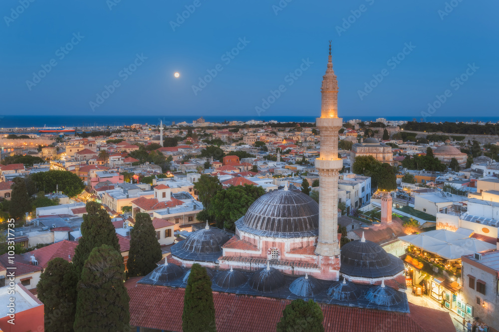 Panorama of the Old Town and the Mosque of Suleyman evening with the moon. Rhodes Island. Greece