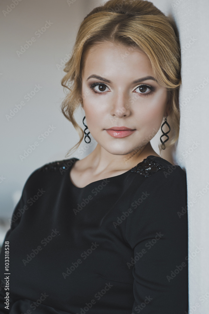 A beautiful girl in a black dress with makeup and hair 5300. A beautiful girl in a black dress with makeup and hair 5300.