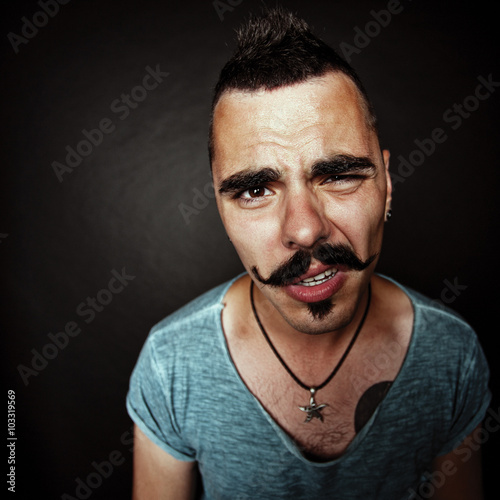 a young man with a mustache after party