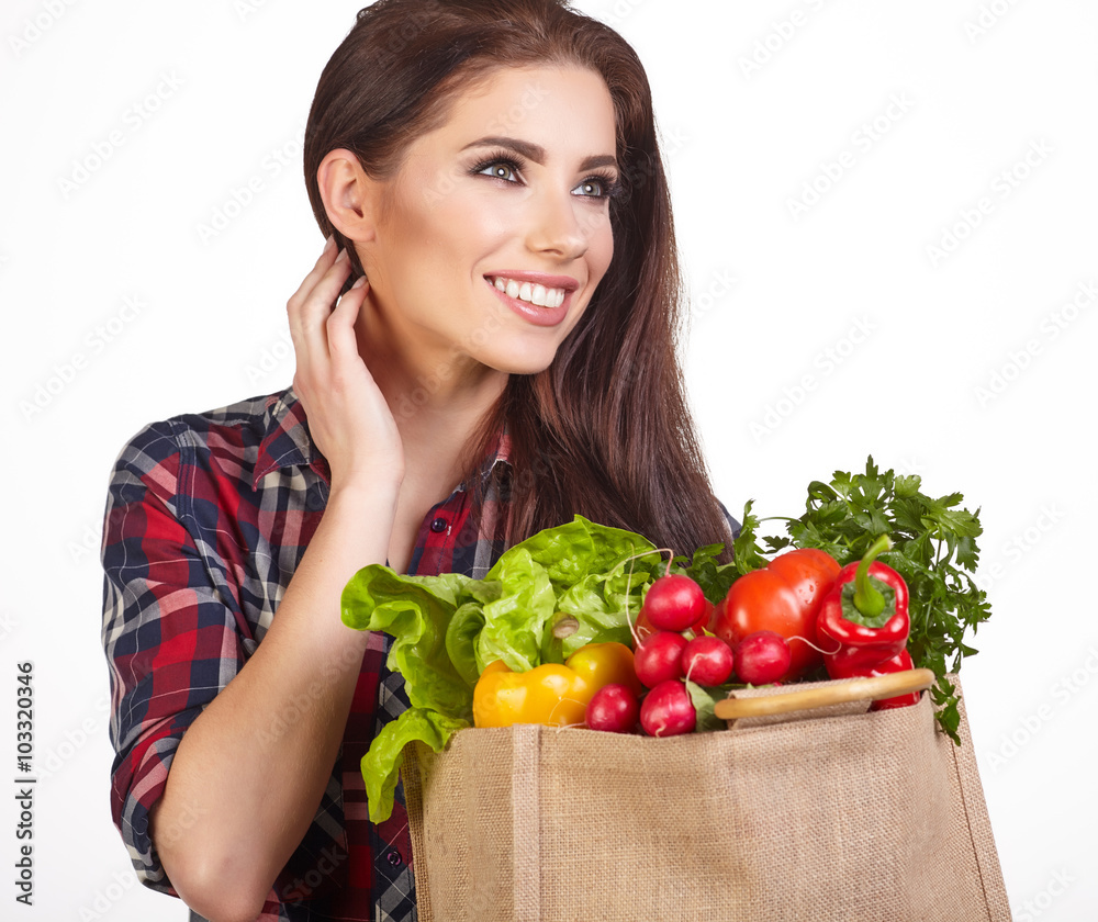 Young woman with a grocery shopping bag. Isolated on white backg Young woman with a grocery shopping bag. Isolated on white backg