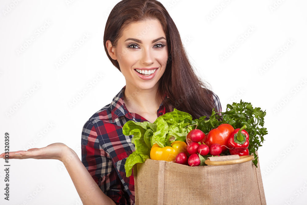 Young woman with a grocery shopping bag. Isolated on white backg Young woman with a grocery shopping bag. Isolated on white backg
