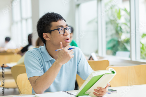 Asian student studying in the library.