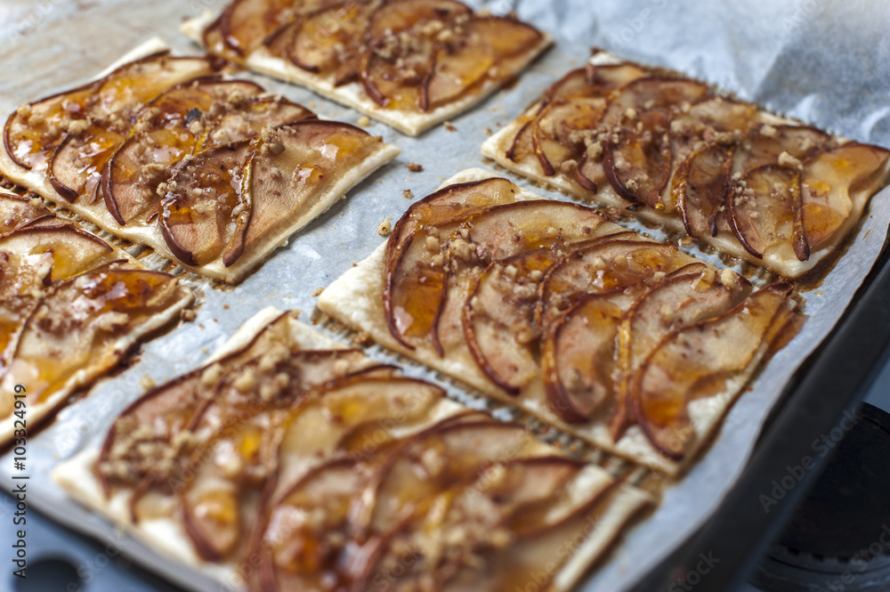 Tarte with puff pastry, pears, walnuts on baking pan