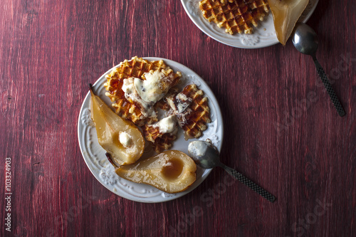Wallpaper Mural Waffles, pears cooked in sugar syrap and ice cream on white plate, spoons on blue wooden table Torontodigital.ca