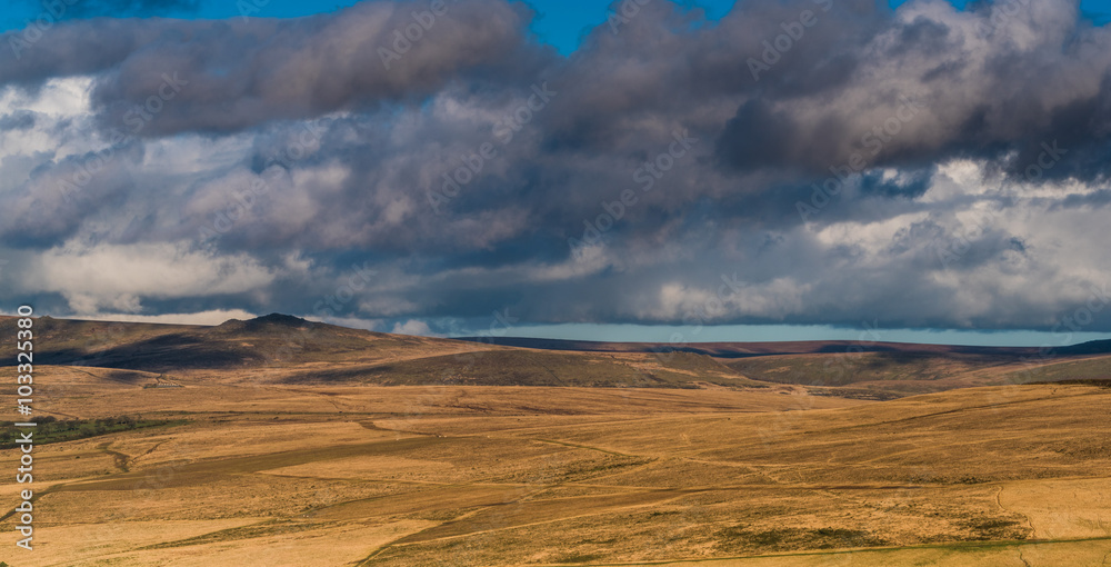 Stormy cloud rolling over hills.