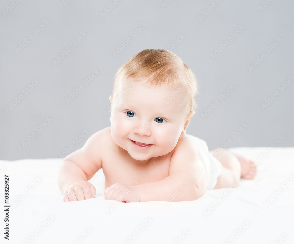 Portrait of a cute smiling infant baby crawling in a diaper. Portrait of a cute smiling infant baby crawling in a diaper.