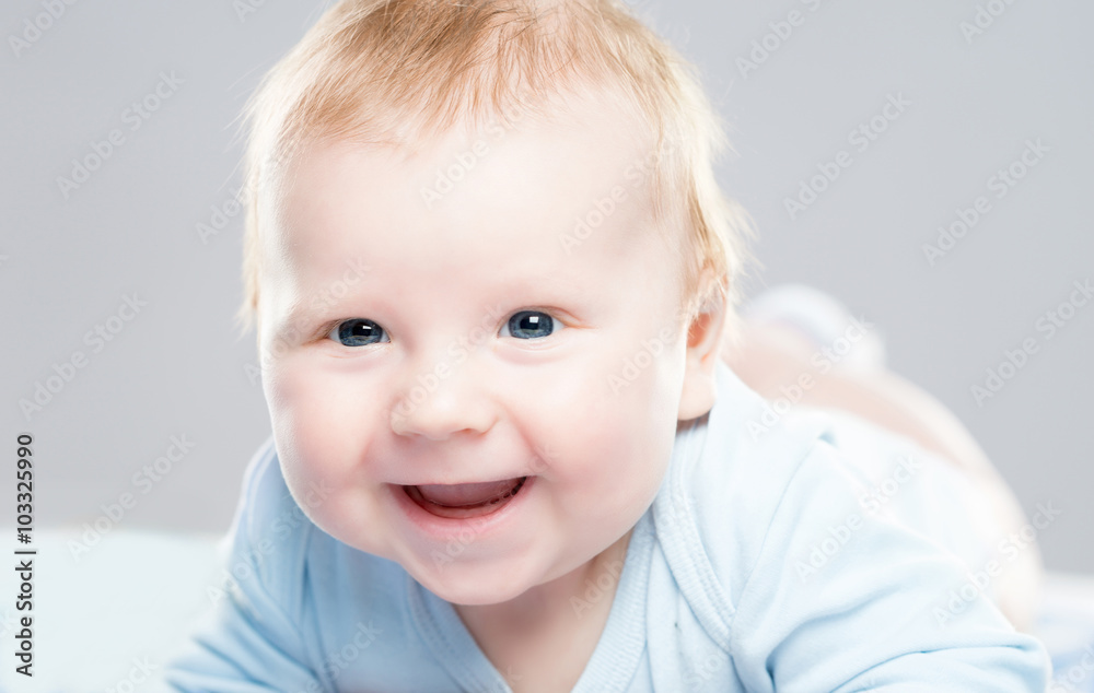 Portrait of a cute smiling infant baby. Happy childhood concept.