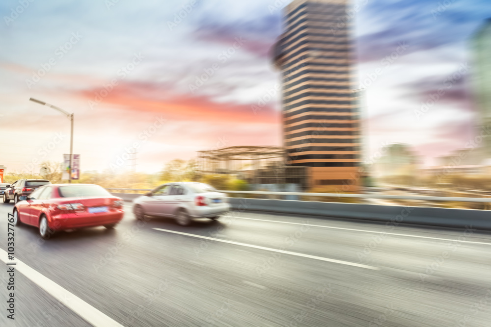 Car driving on road, motion blur