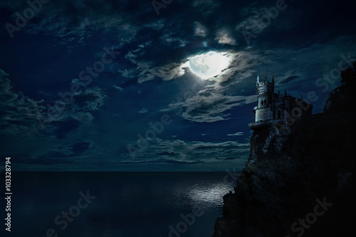 Night seascape with the moon and the castle on the hill